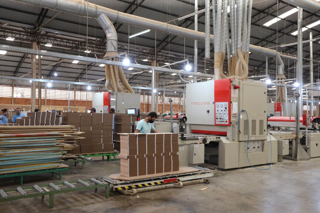 Industrial furniture factory in Brazil with automated machinery and packaging systems, showcasing export-ready MDF and particleboard production.