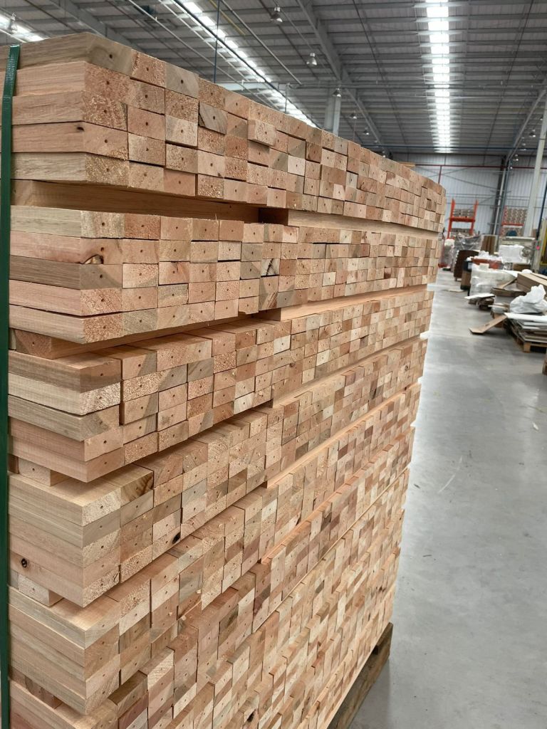 Stacked Brazilian hardwood lumber inside a furniture factory prepared for moisture control and export furniture manufacturing.