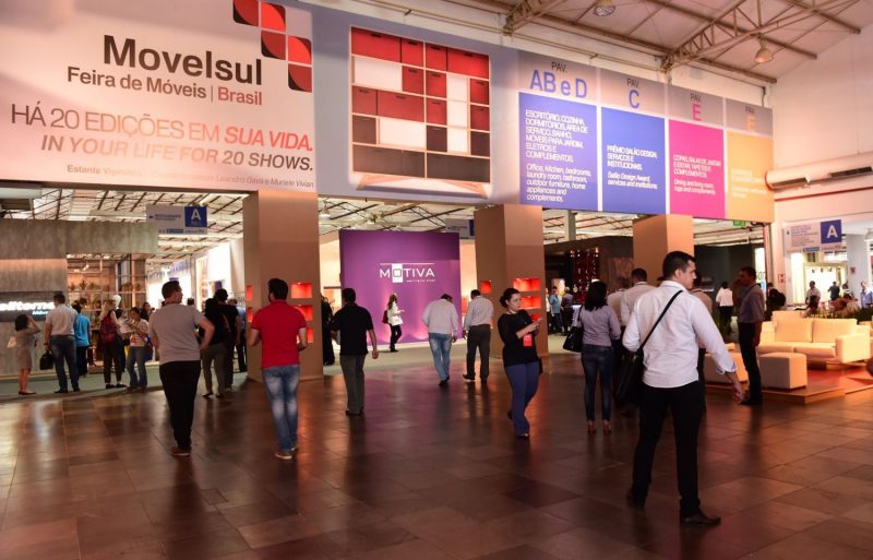 International buyers walking through the main pavilion entrance of the Movelsul Brasil furniture trade fair in Bento Goncalves.